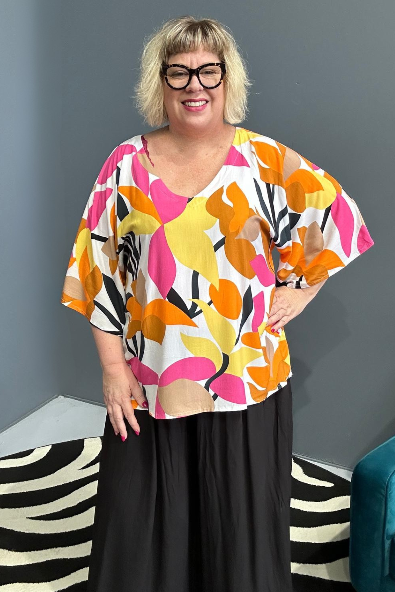 Plus-size orange top with a flowy fit and stylish drape.