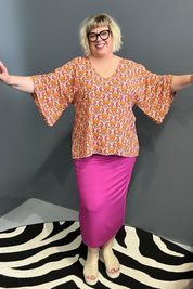 Plus-size orange swirl top with a stylish, flowy fit.