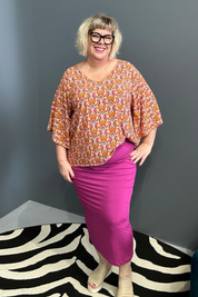 Plus-size orange swirl top with a stylish, flowy fit.