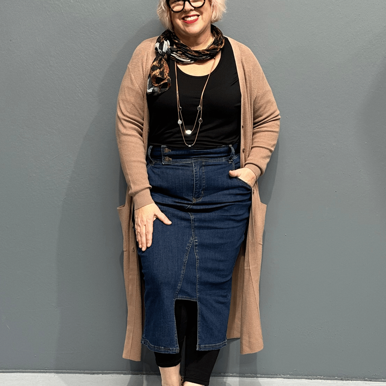 High-waisted stretch denim skirt called 'EMBRACE' designed to flatter curves, perfect for pairing with shirts or tees - Dark Denim.