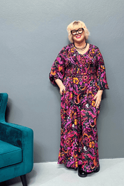Plus-size wide-leg floral pants with a watercolor design, featuring a flattering high waist and made from cool rayon for year-round wear.