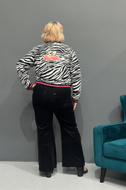 Trendy plus size bomber jacket with bamboo lining, rainproof fabric, cuff detailing, and sequined flamingos on the back.