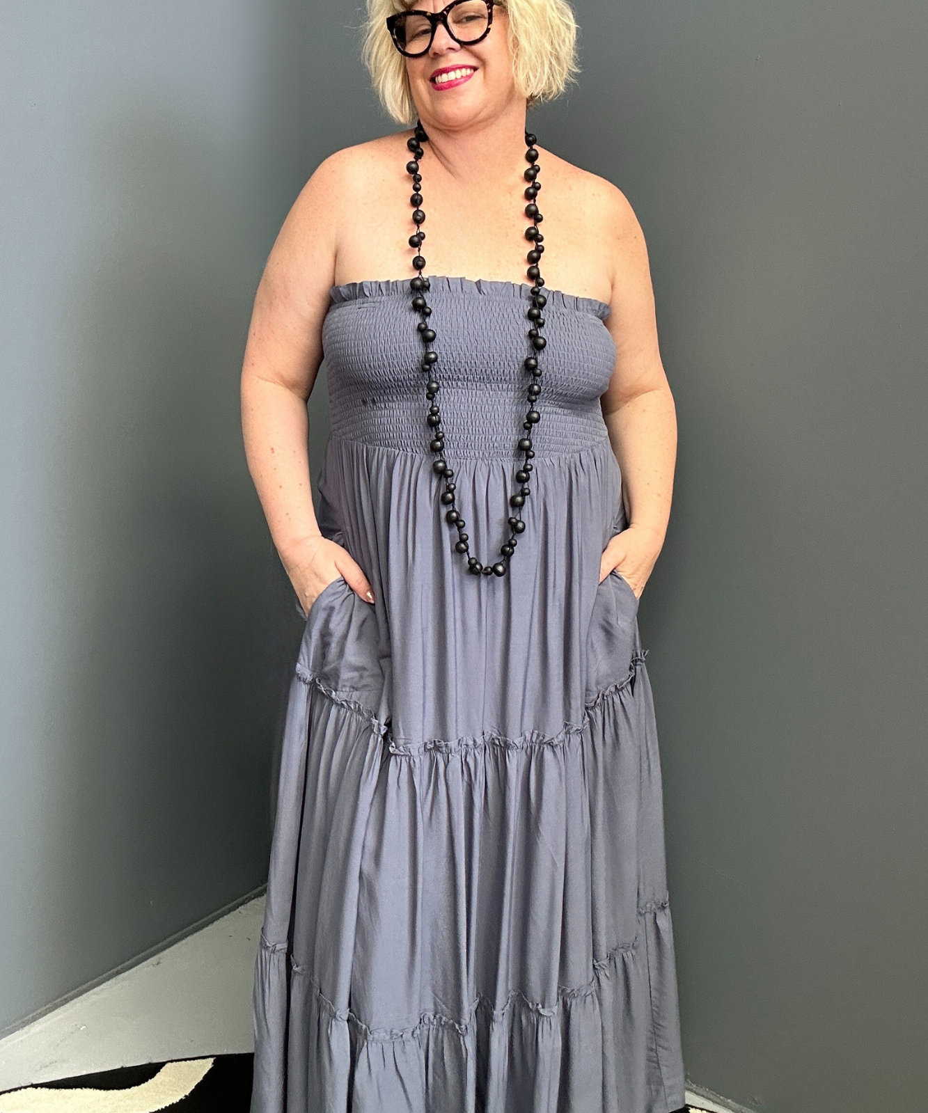 Plus-size blue maxi dress with a flattering wrap design and soft drape.