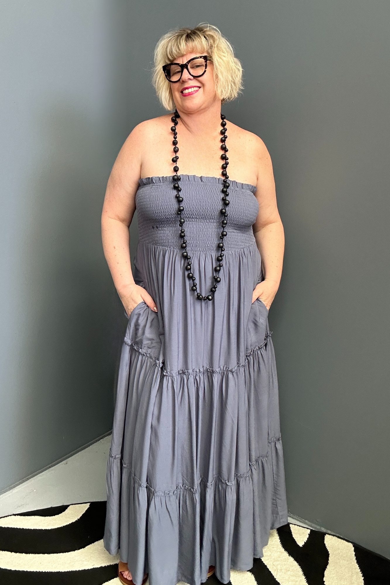 Plus-size blue maxi dress with a flattering wrap design and soft drape.