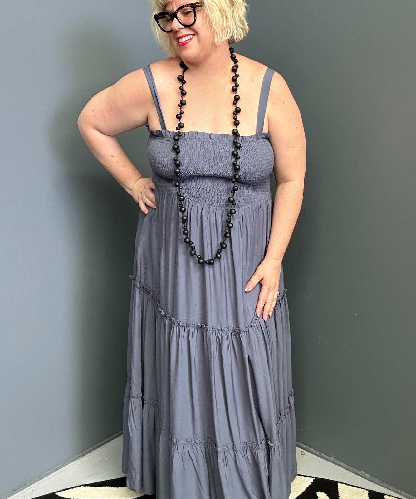 Plus-size blue maxi dress with a flattering wrap design and soft drape.