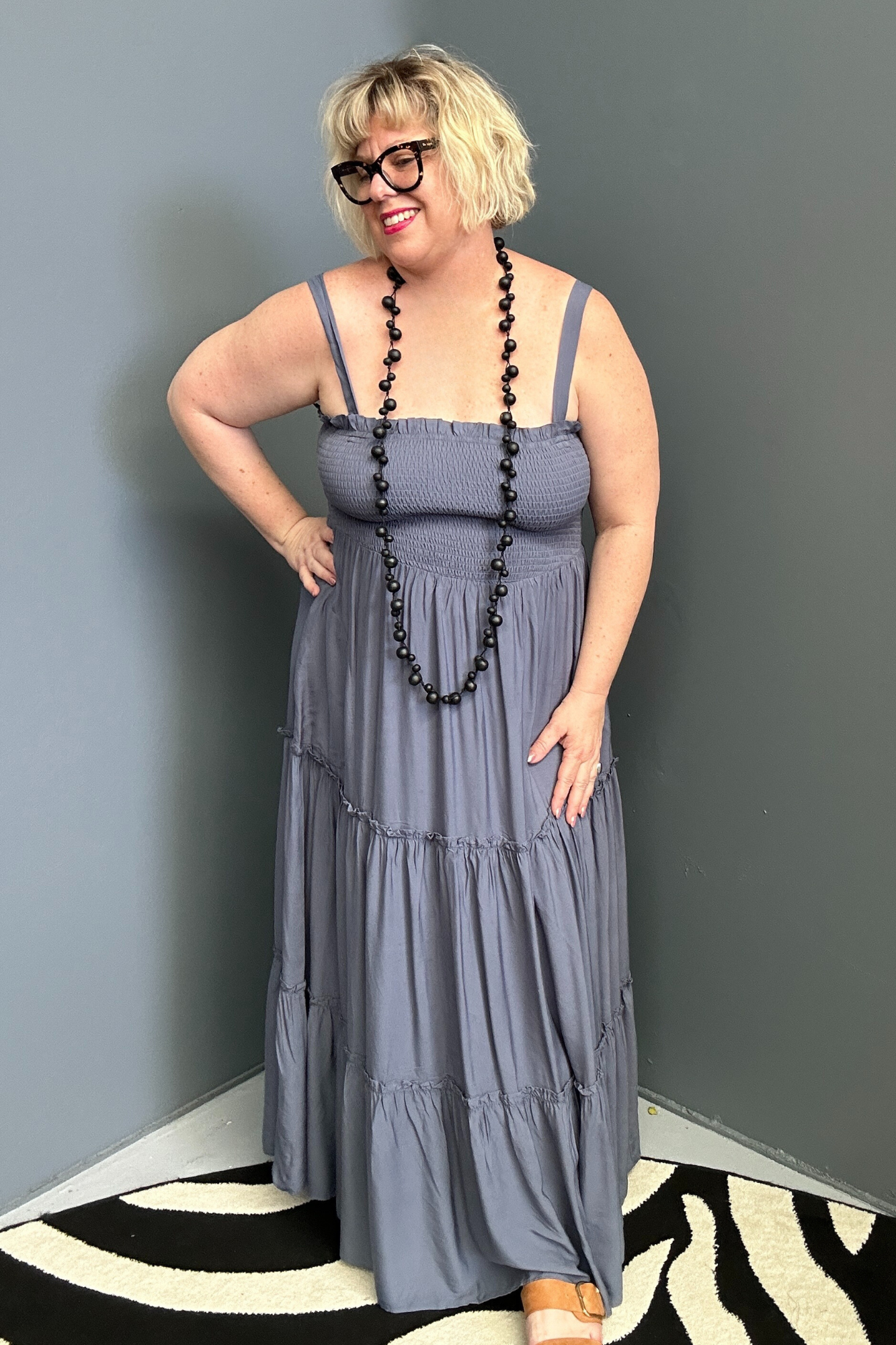 Plus-size blue maxi dress with a flattering wrap design and soft drape.