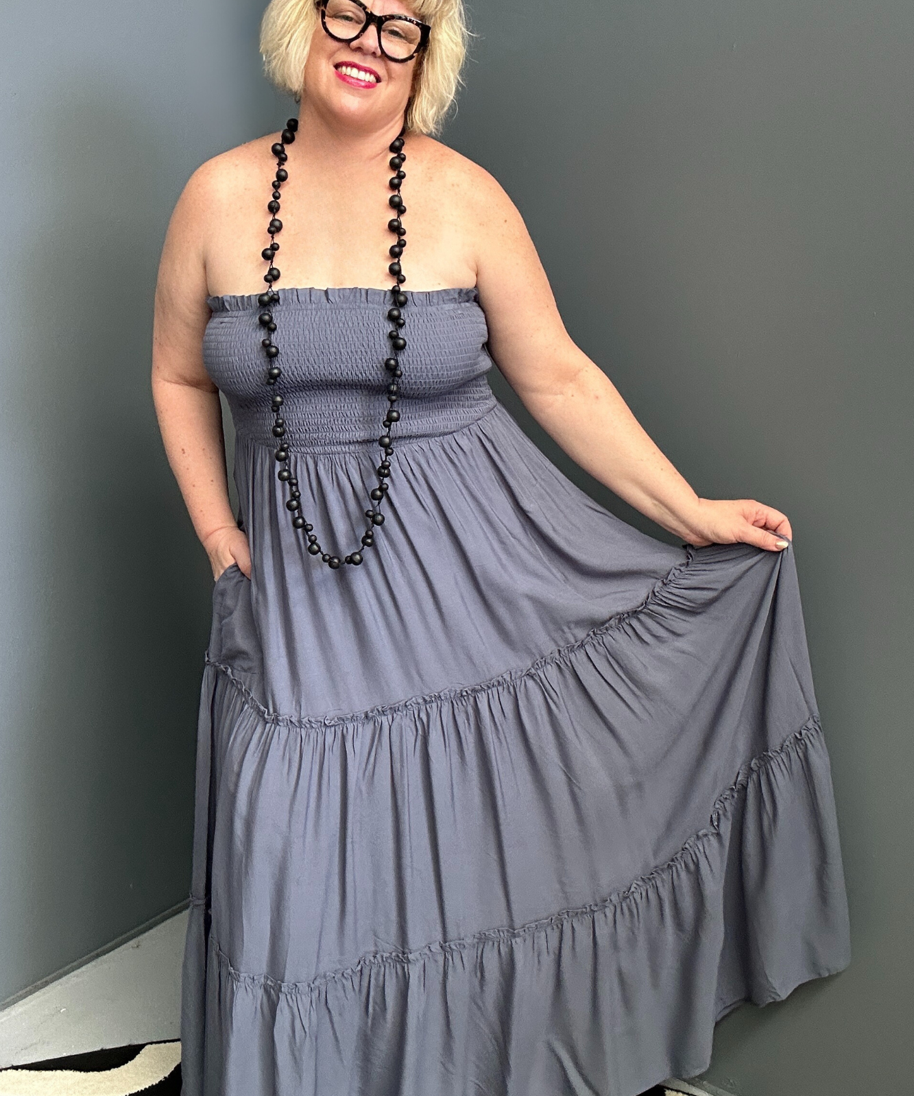 Plus-size blue maxi dress with a flattering wrap design and soft drape.
