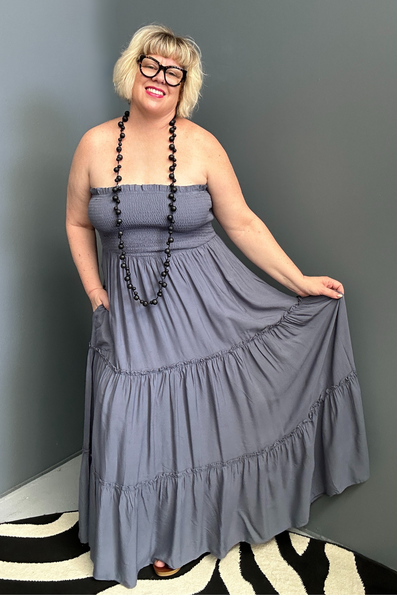 Plus-size blue maxi dress with a flattering wrap design and soft drape.