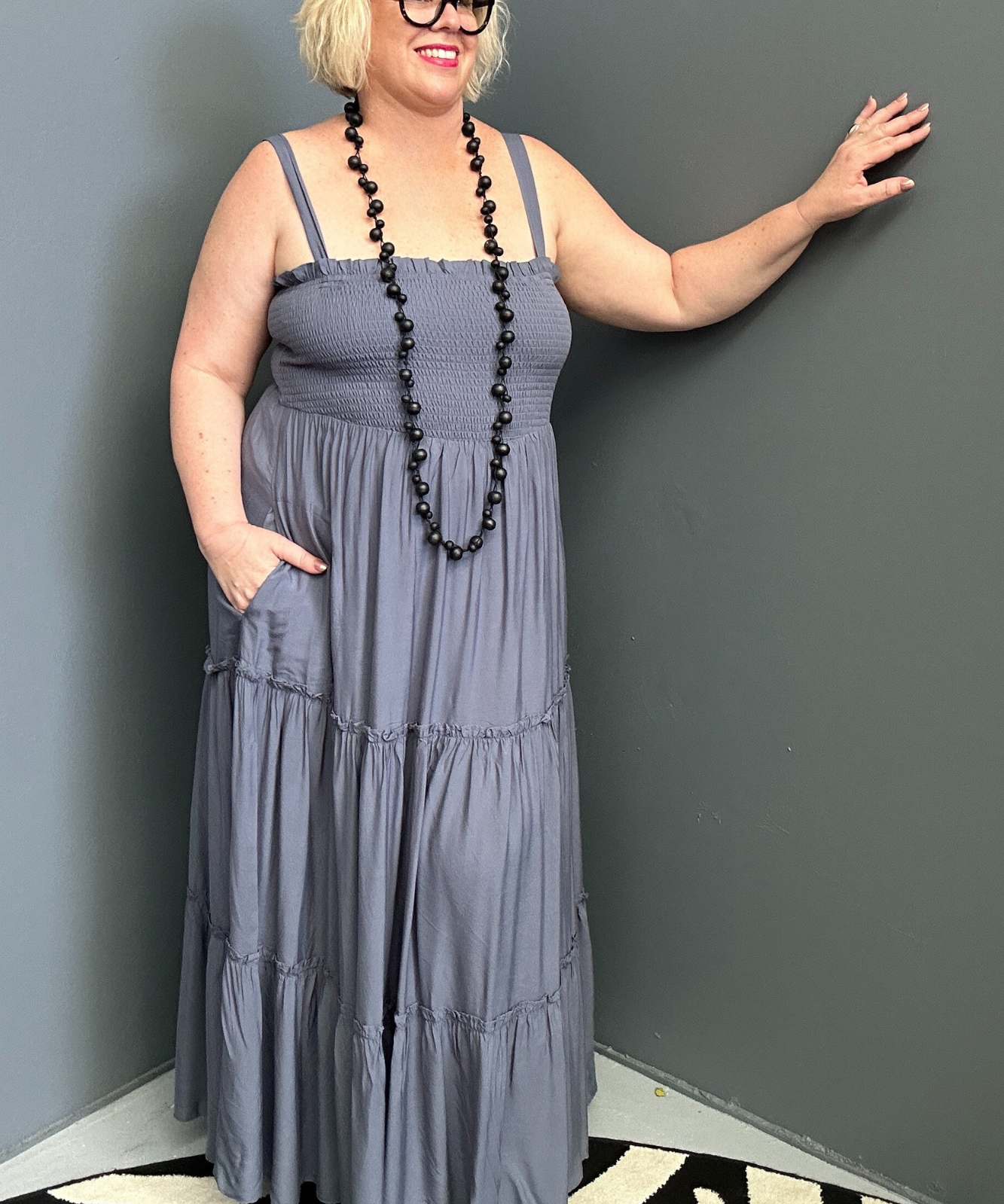 Plus-size blue maxi dress with a flattering wrap design and soft drape.