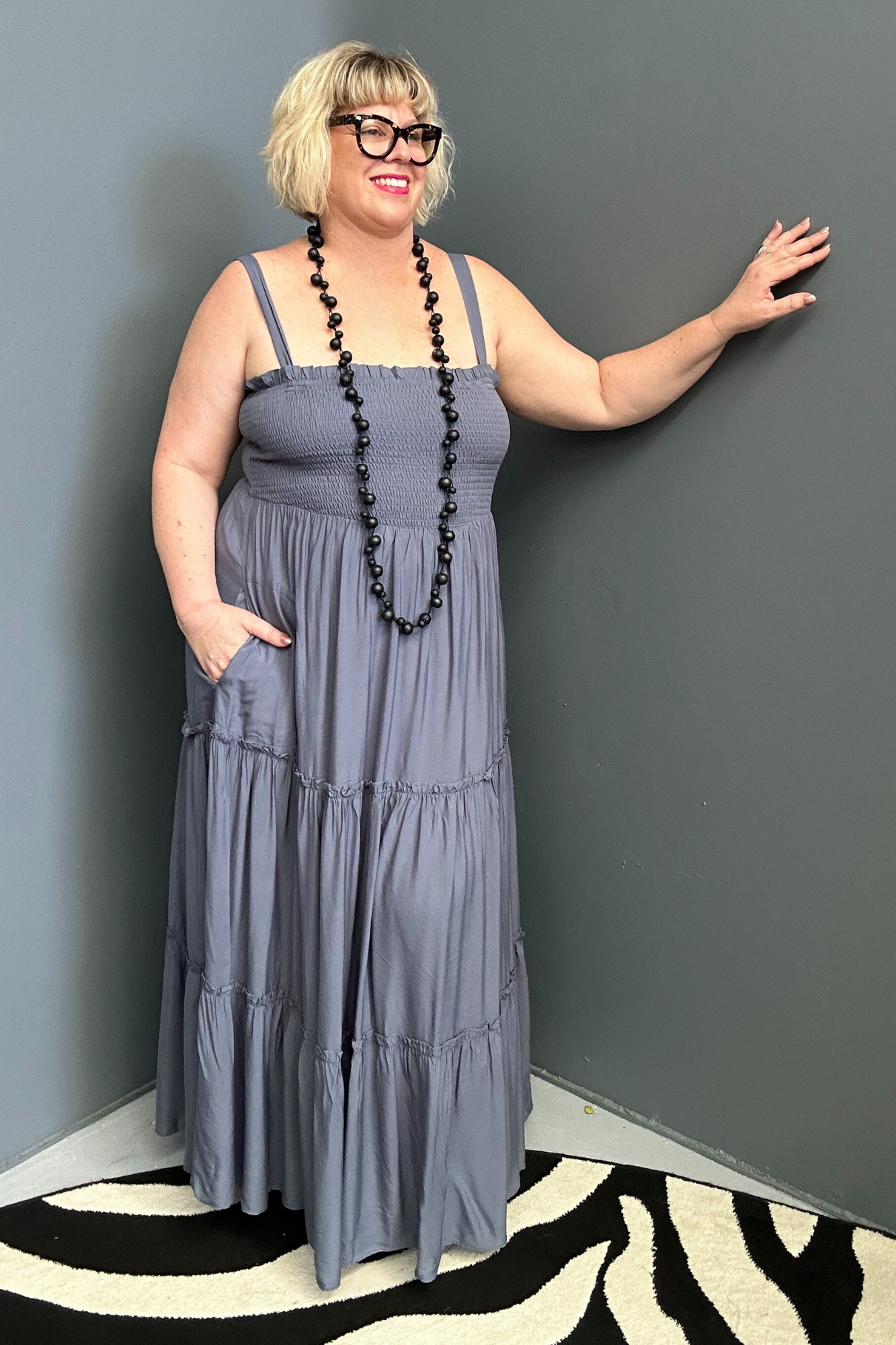 Plus-size blue maxi dress with a flattering wrap design and soft drape.