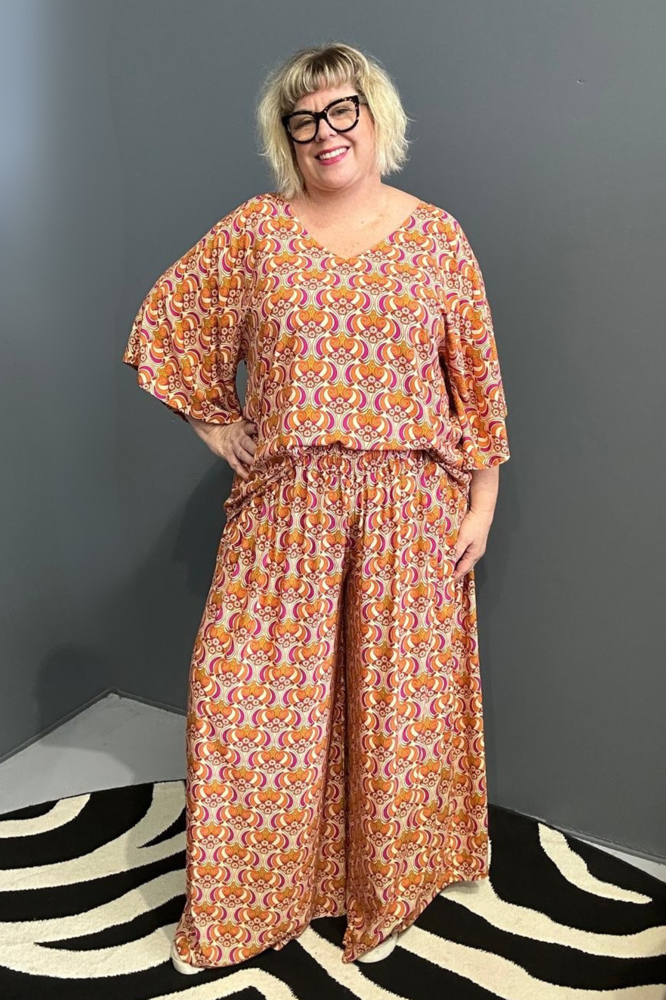 Flowy palazzo pants with a vibrant Orange Swirl print.