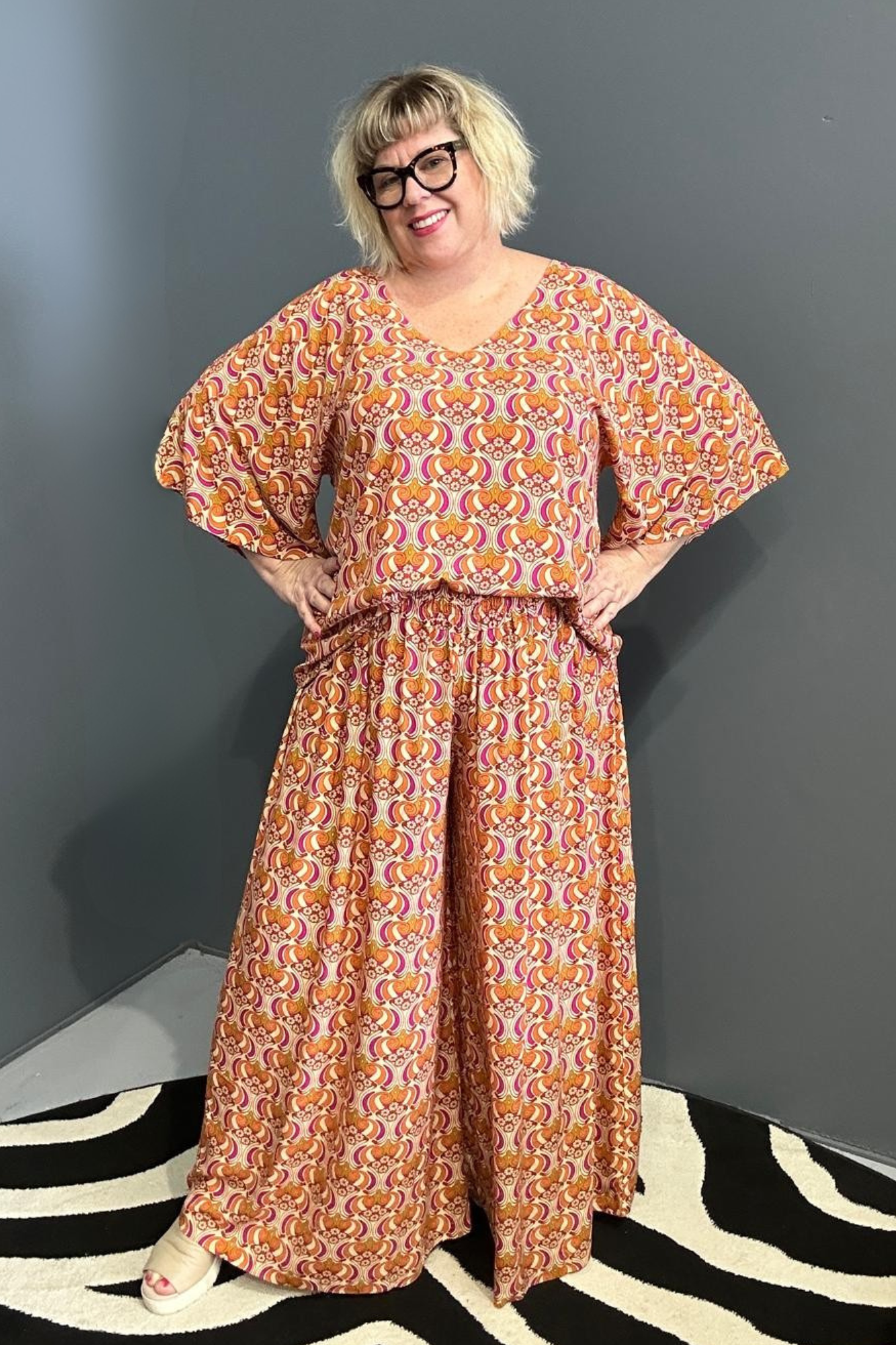 Flowy palazzo pants with a vibrant Orange Swirl print.