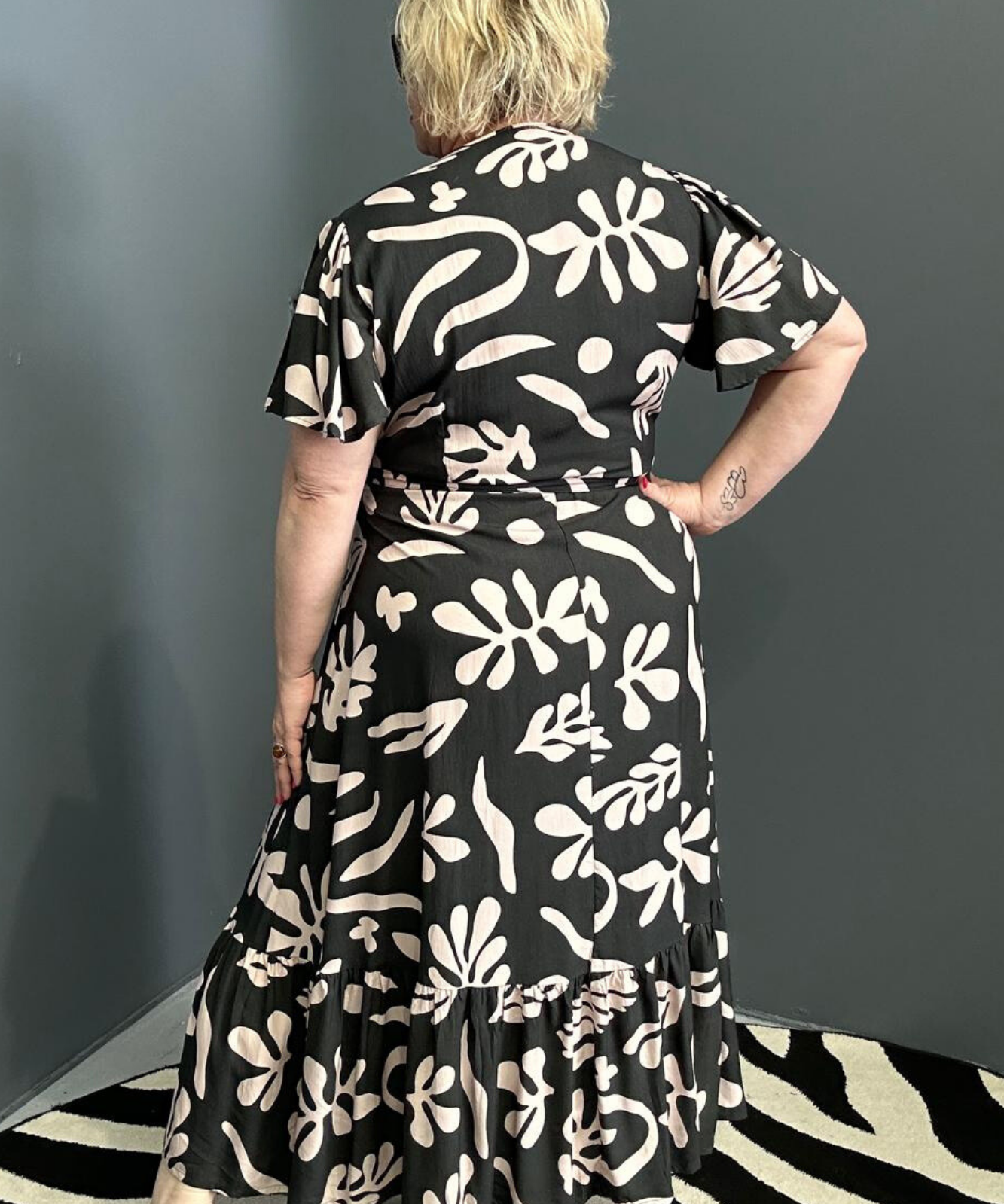 Flattering plus-size wrap dress in black and creme.