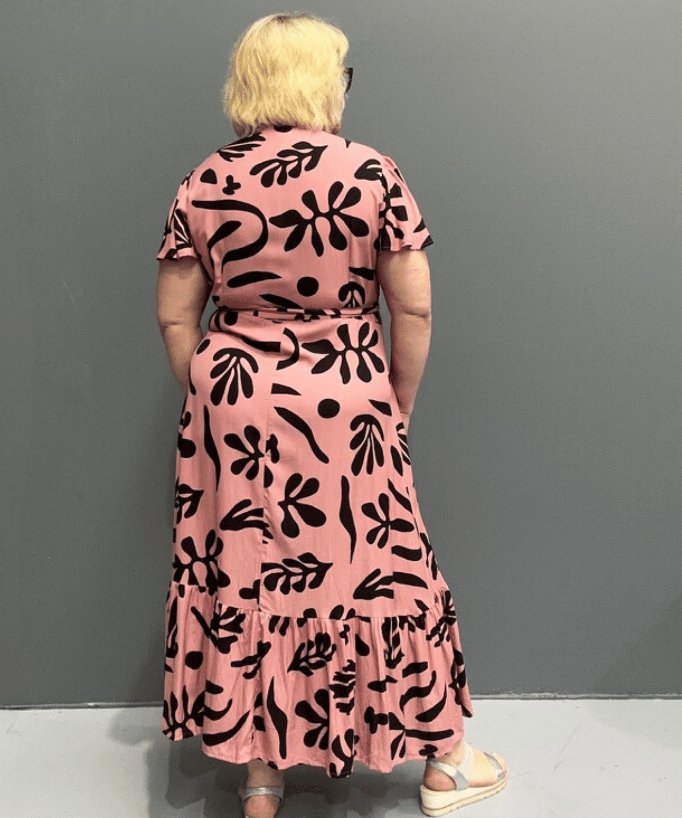 Plus-size pink wrap dress with a flattering fit and flowy silhouette.