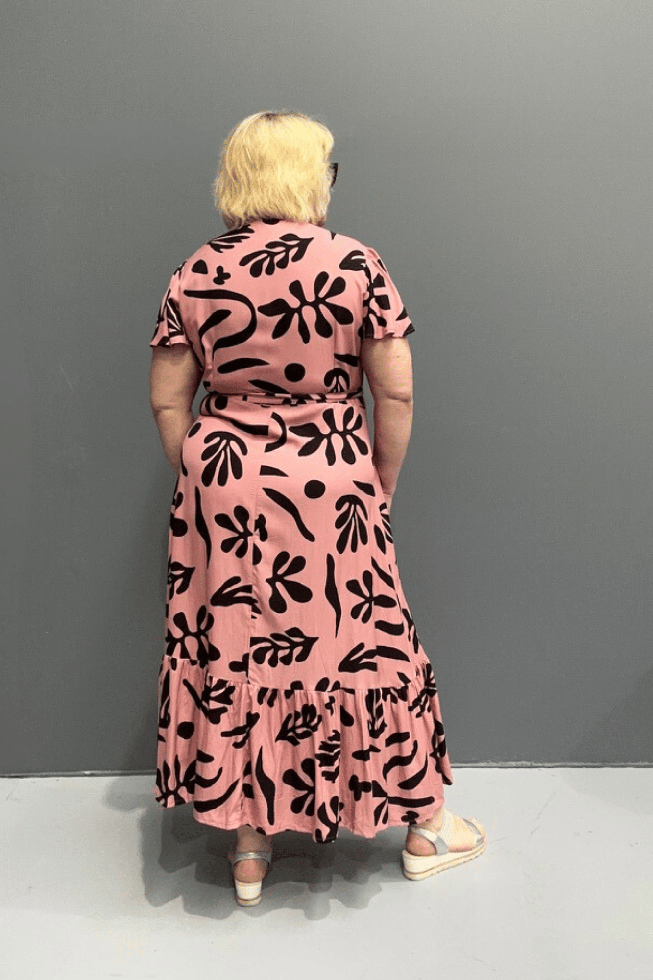 Plus-size pink wrap dress with a flattering fit and flowy silhouette.
