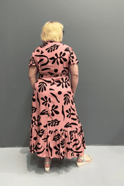 Plus-size pink wrap dress with a flattering fit and flowy silhouette.