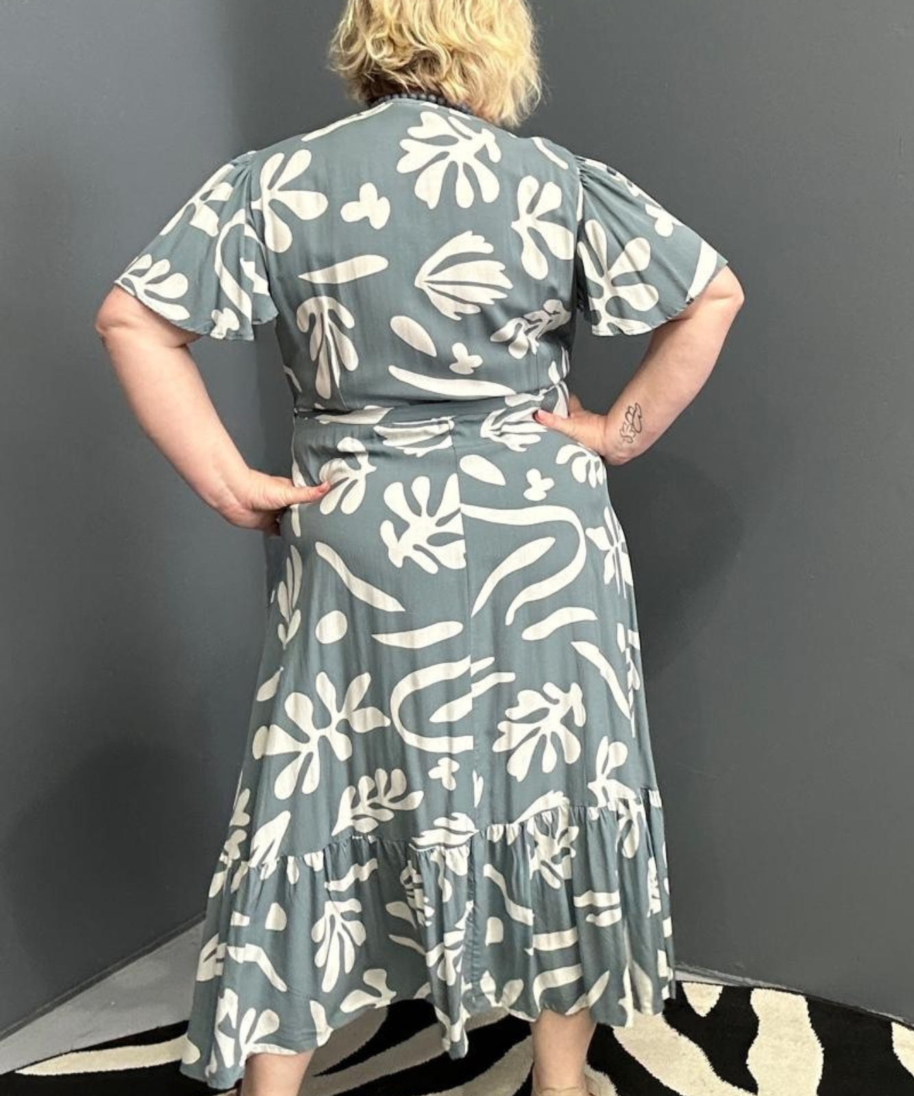 Flattering plus-size wrap dress in grey and creme tones.