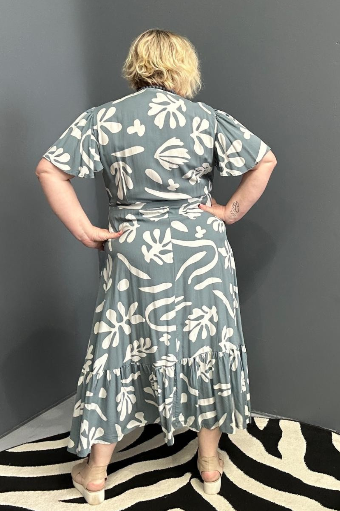 Flattering plus-size wrap dress in grey and creme tones.