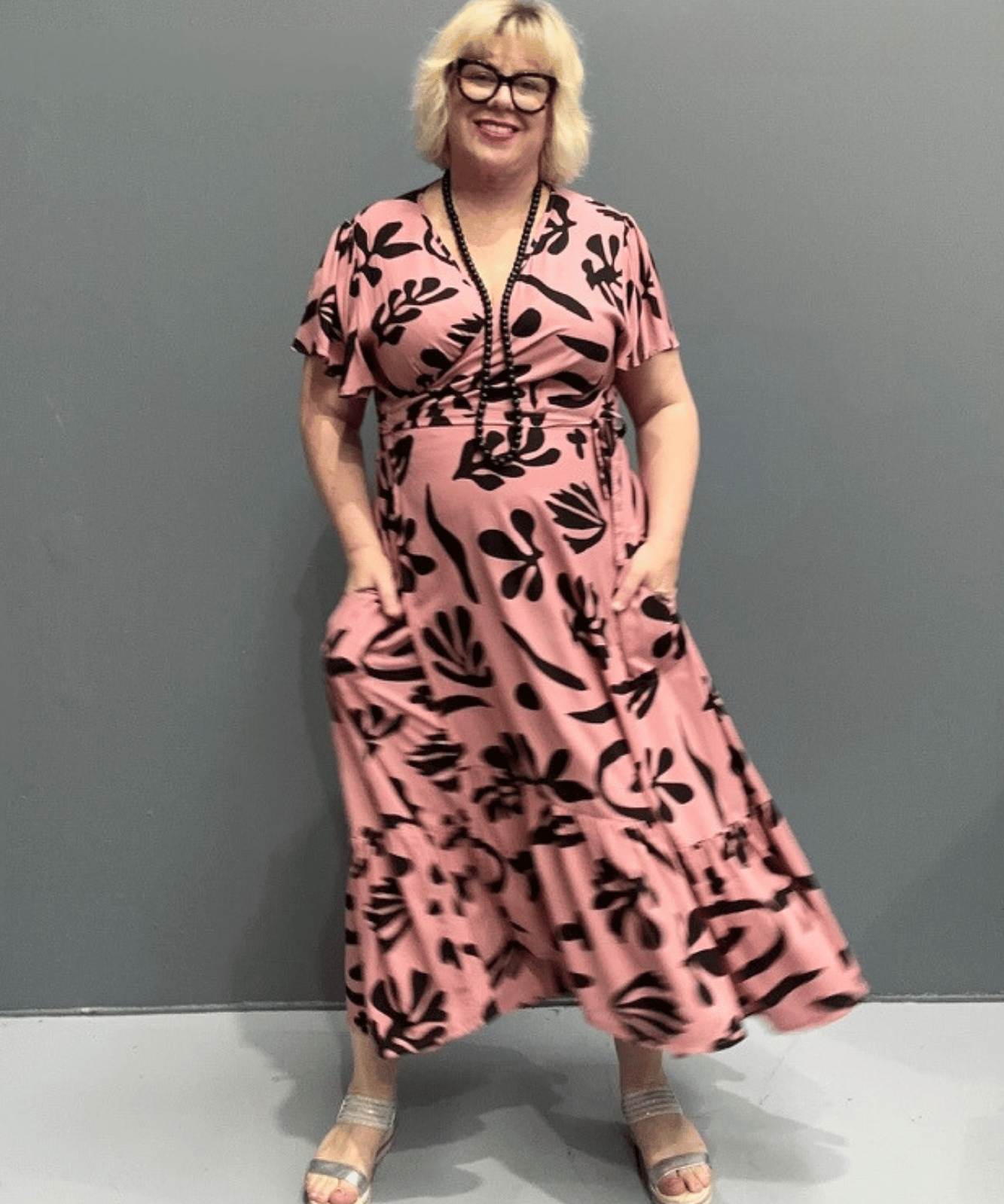 Plus-size pink wrap dress with a flattering fit and flowy silhouette.
