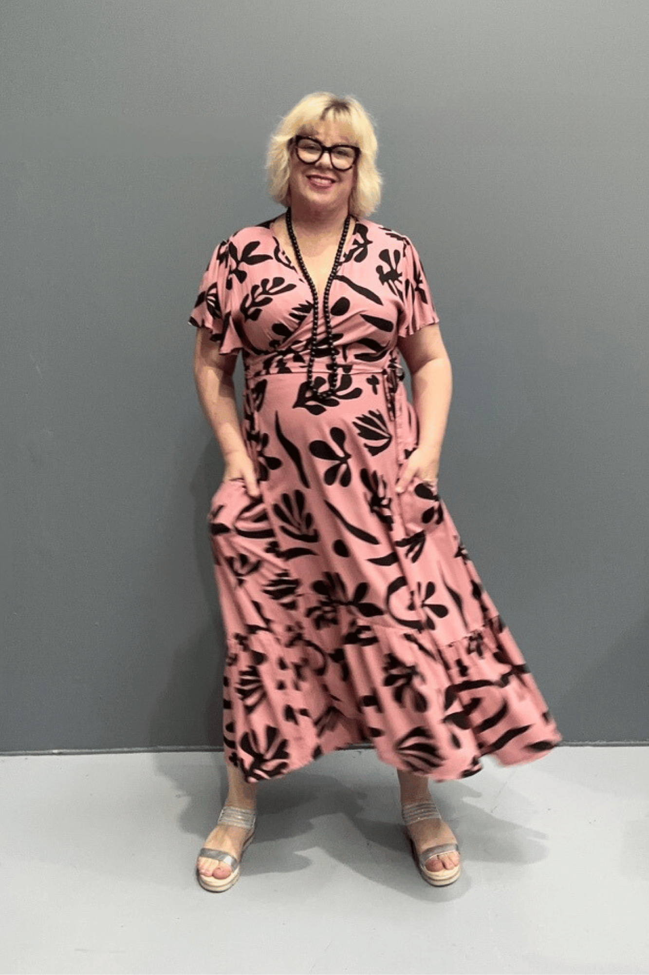 Plus-size pink wrap dress with a flattering fit and flowy silhouette.
