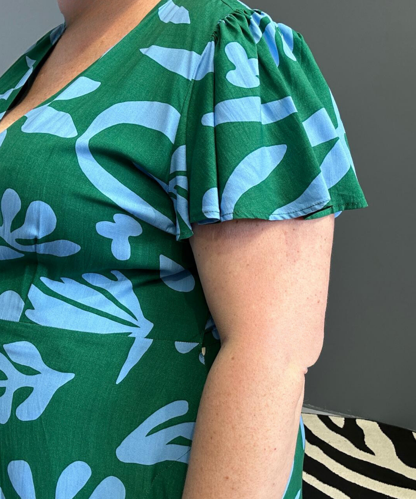 Flattering plus-size wrap dress in green and blue hues.