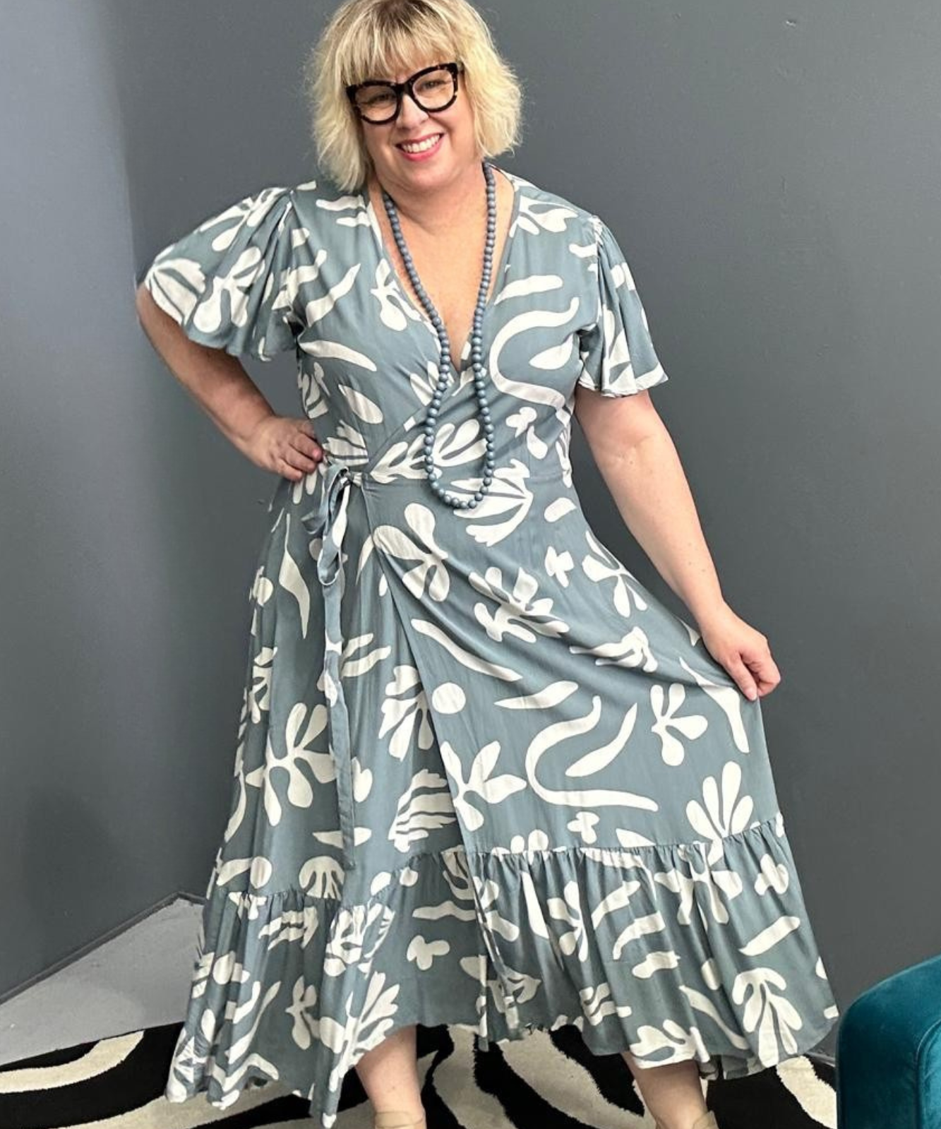 Flattering plus-size wrap dress in grey and creme tones.