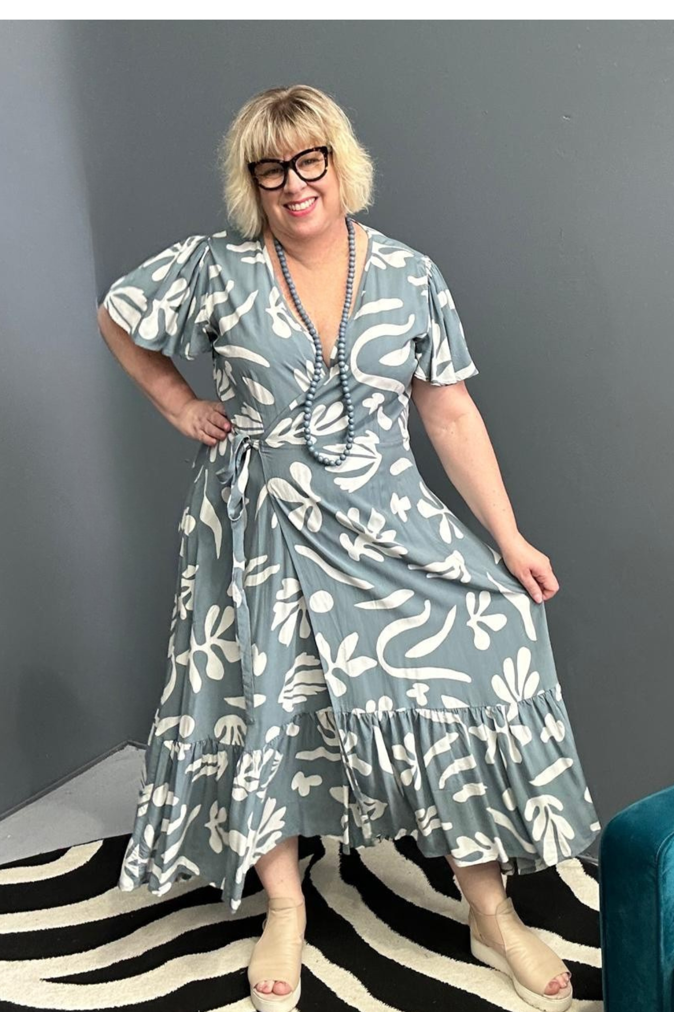 Flattering plus-size wrap dress in grey and creme tones.