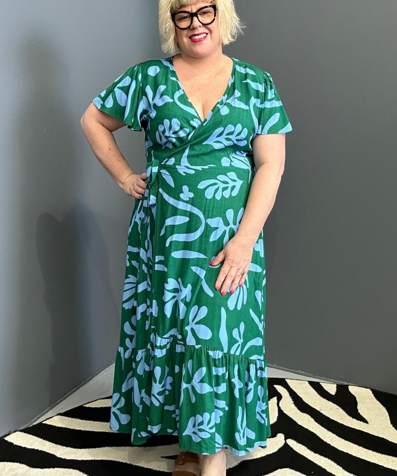 Flattering plus-size wrap dress in green and blue hues.