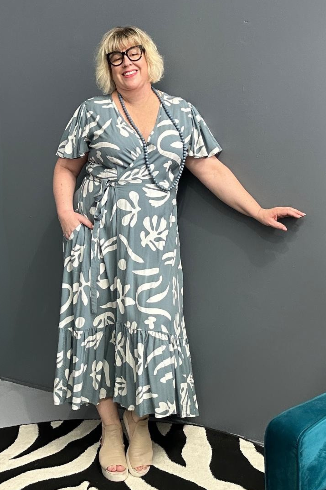 Flattering plus-size wrap dress in grey and creme tones.