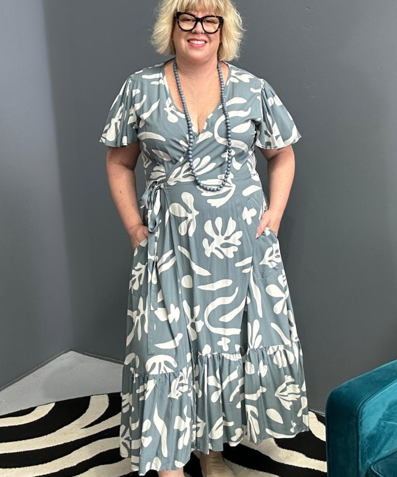 Flattering plus-size wrap dress in grey and creme tones.