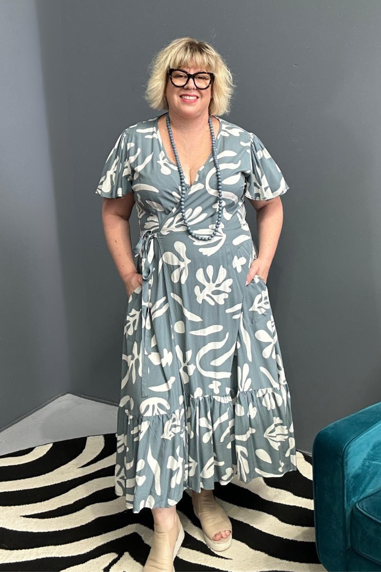 Flattering plus-size wrap dress in grey and creme tones.