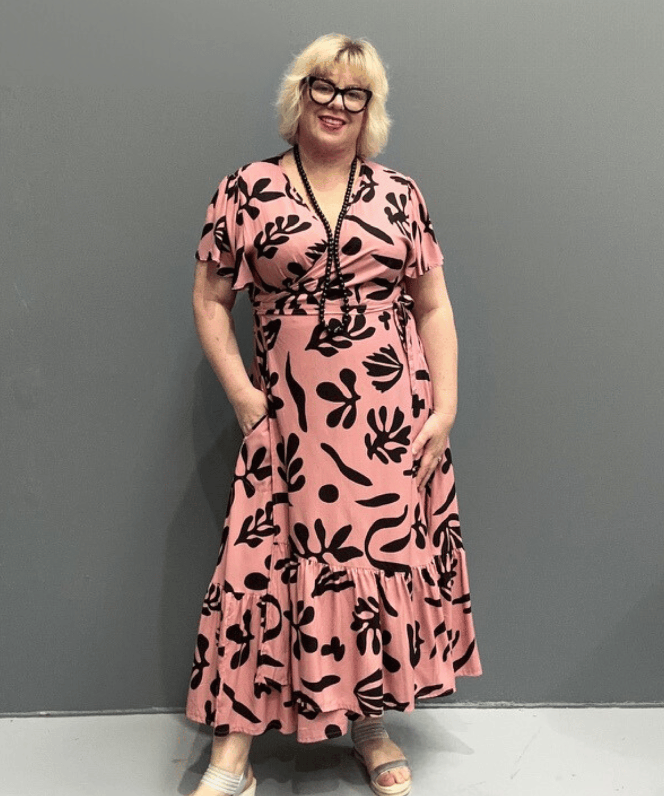 PLUS SIZE WRAP Plus-size pink wrap dress with a flattering fit and flowy silhouette.