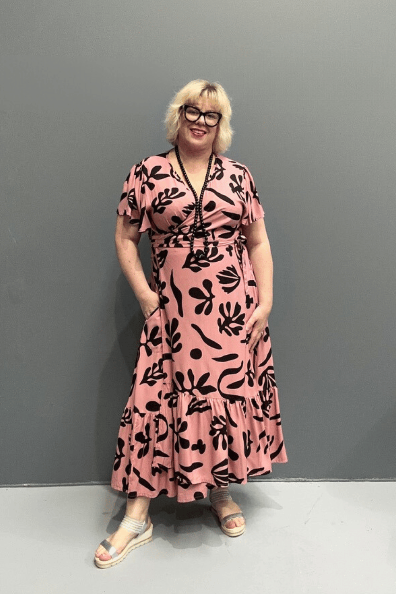 PLUS SIZE WRAP Plus-size pink wrap dress with a flattering fit and flowy silhouette.