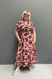 PLUS SIZE WRAP Plus-size pink wrap dress with a flattering fit and flowy silhouette.