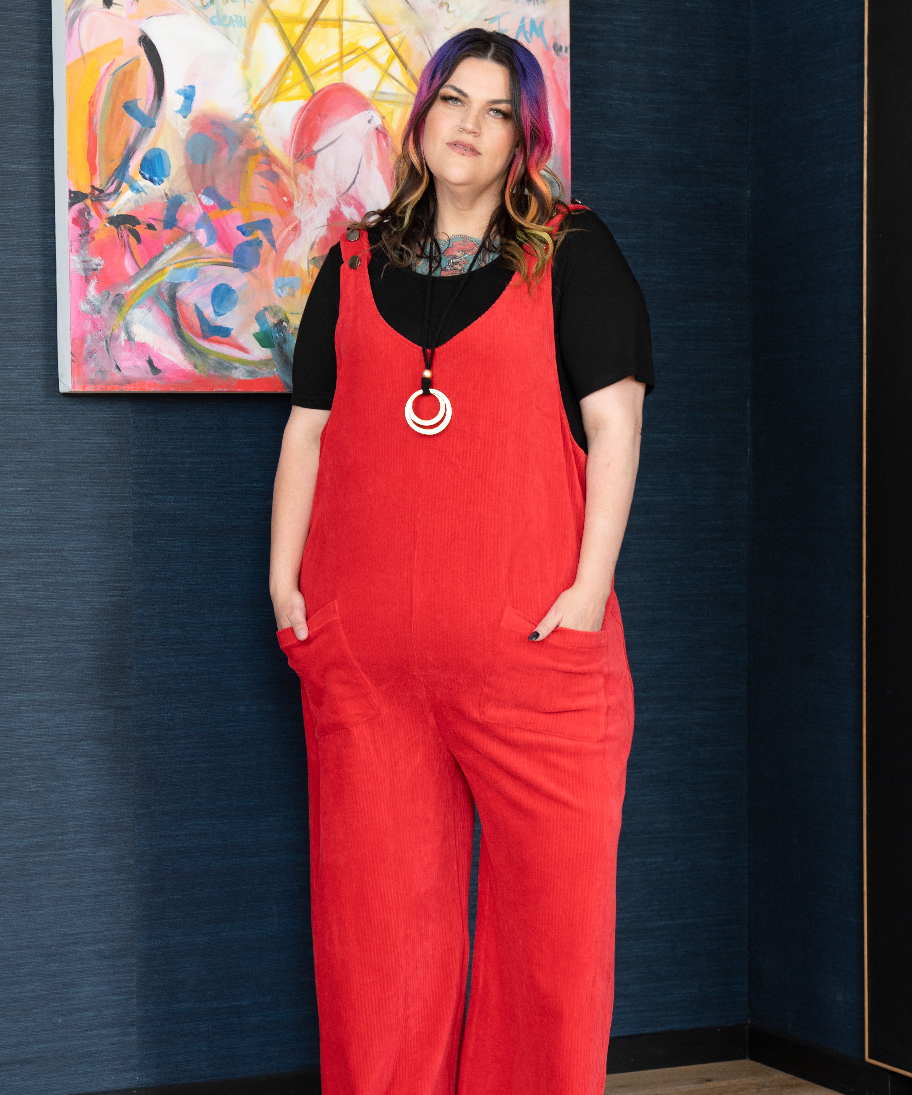 ‘LOLA’ overalls in breathable stretch corduroy, designed for plus size women, featuring a stylish casual look paired with a body tee and chunky boots.