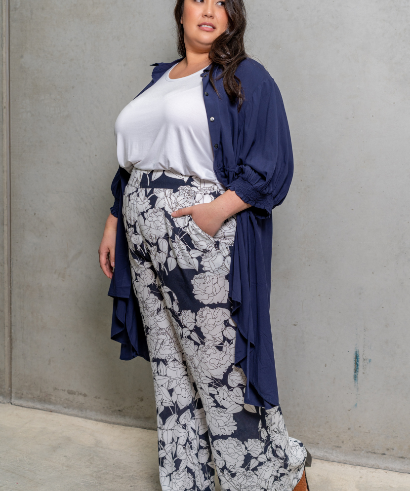 White Rose Pants with wide-leg cut, tapered knee, and cinched high waist, ideal for plus size fashion.