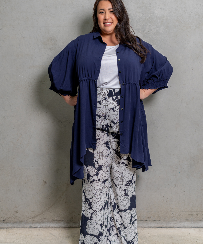 White Rose Pants with wide-leg cut, tapered knee, and cinched high waist, ideal for plus size fashion.