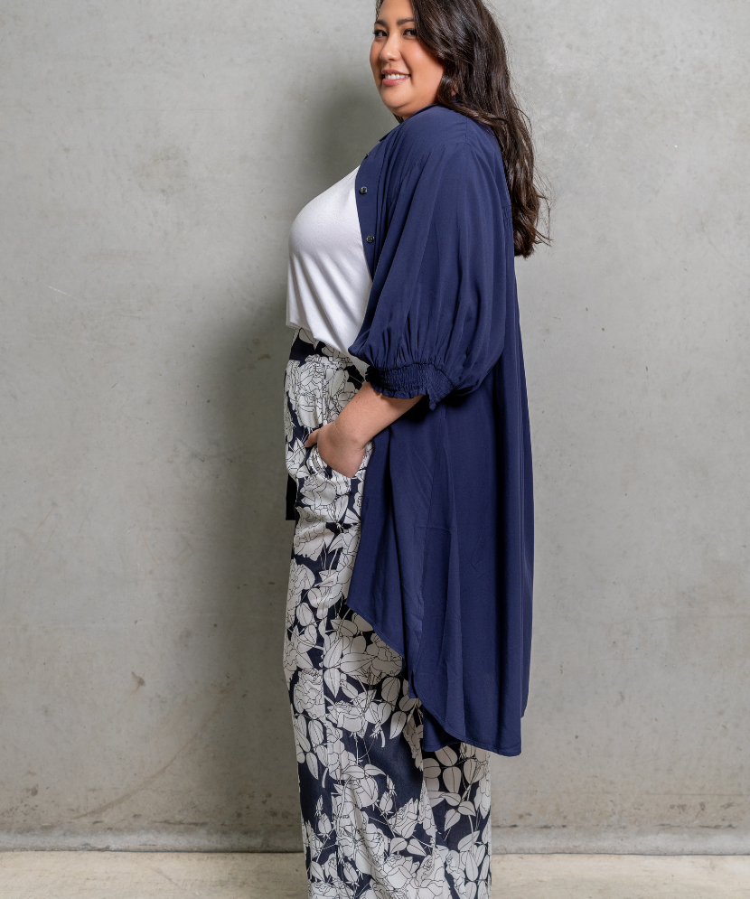 White Rose Pants with wide-leg cut, tapered knee, and cinched high waist, ideal for plus size fashion.
