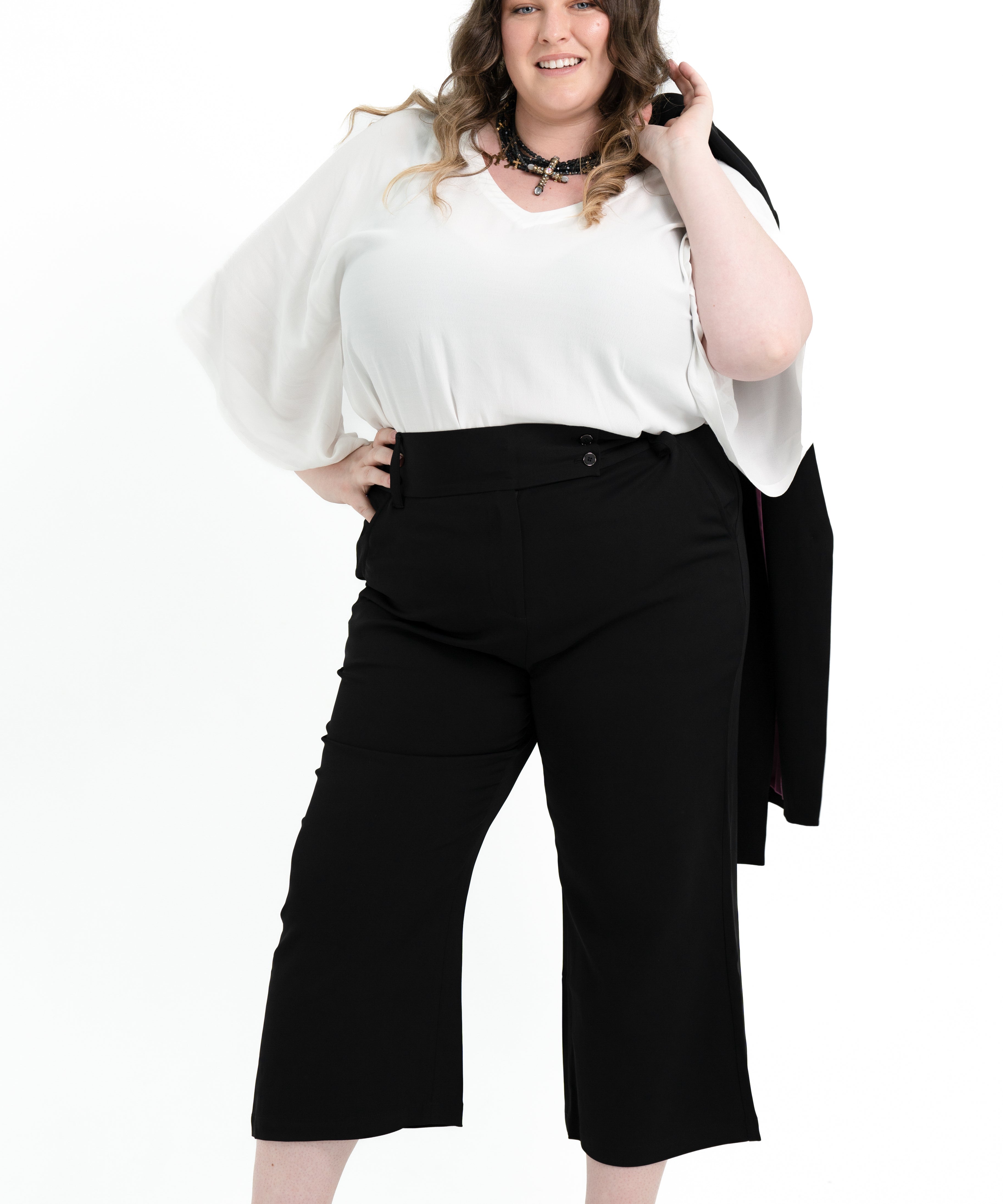 Black stretch crepe 'Power' pant with candy pink pocket lining, designed for plus size women to pair with matching blazer.
