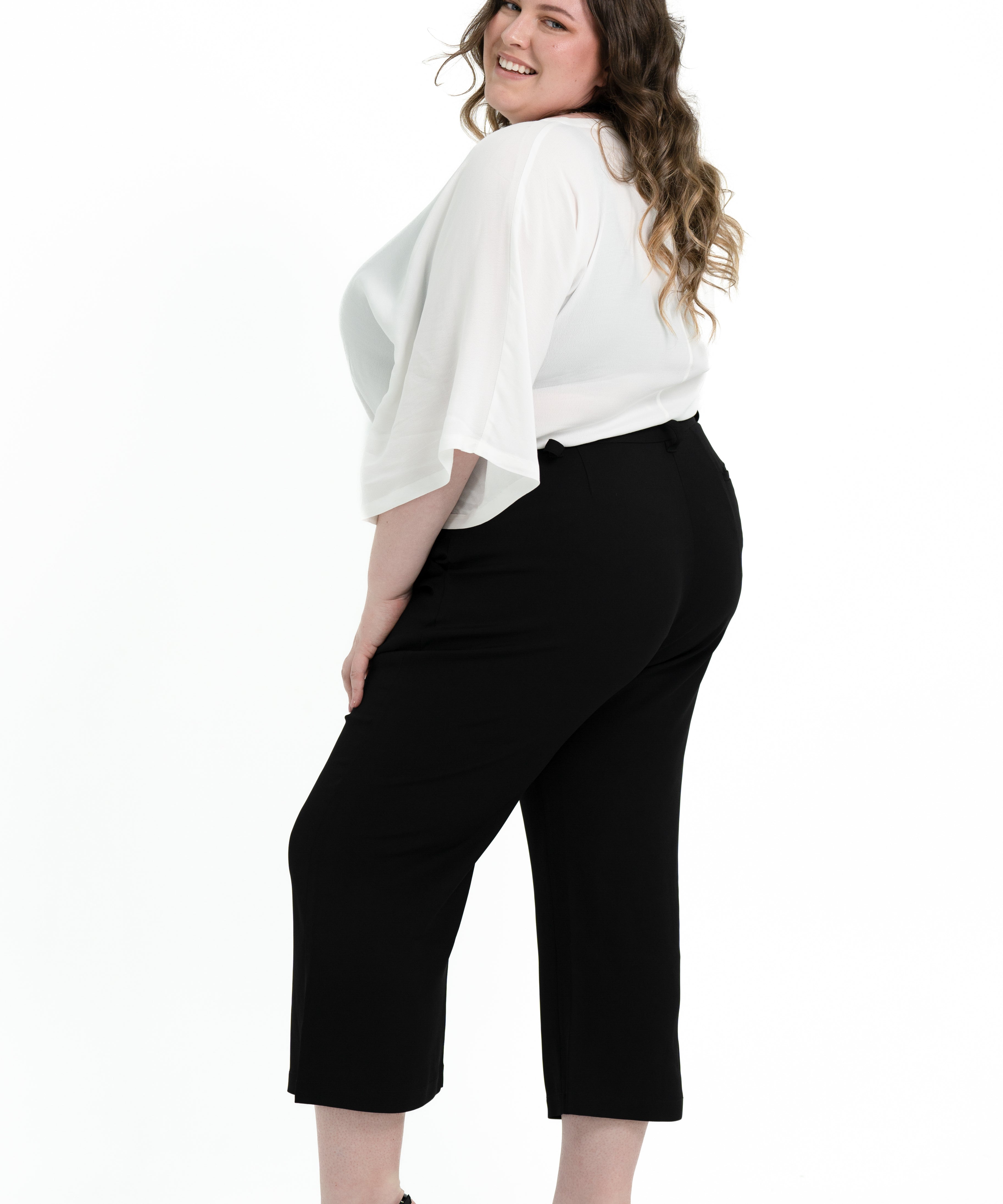 Black stretch crepe 'Power' pant with candy pink pocket lining, designed for plus size women to pair with matching blazer.